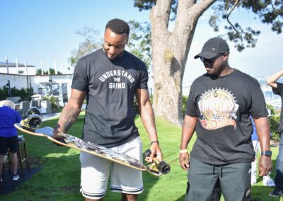 norman powell holding a longboard