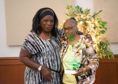 two women holding a plaque